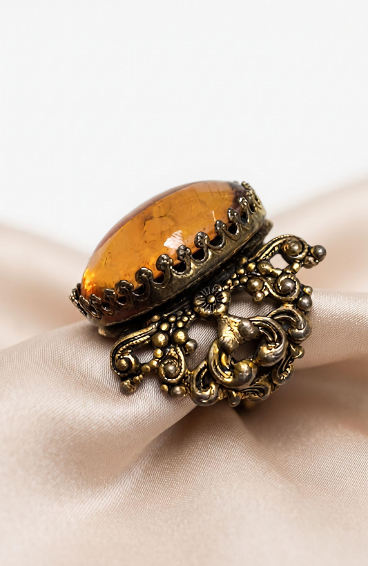 Beautiful peach colored lucite stone in filagree adjustable setting