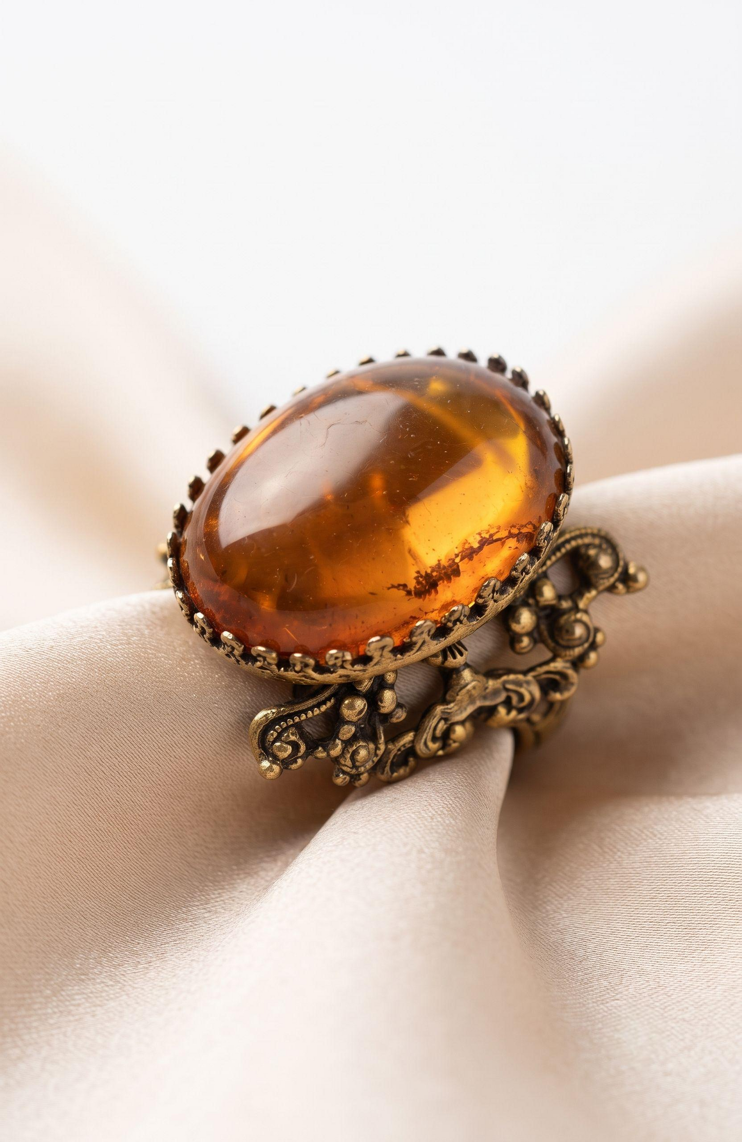 Beautiful peach colored lucite stone in filagree adjustable setting