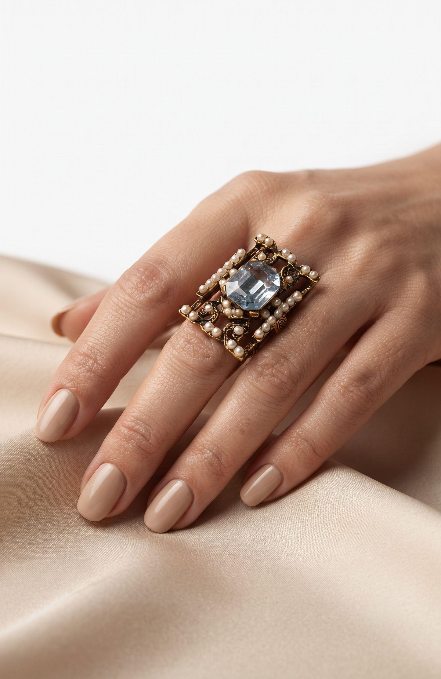 elegant 1940s jumbo cocktail ring with faux aquamarine  center stone  and seed pearls.