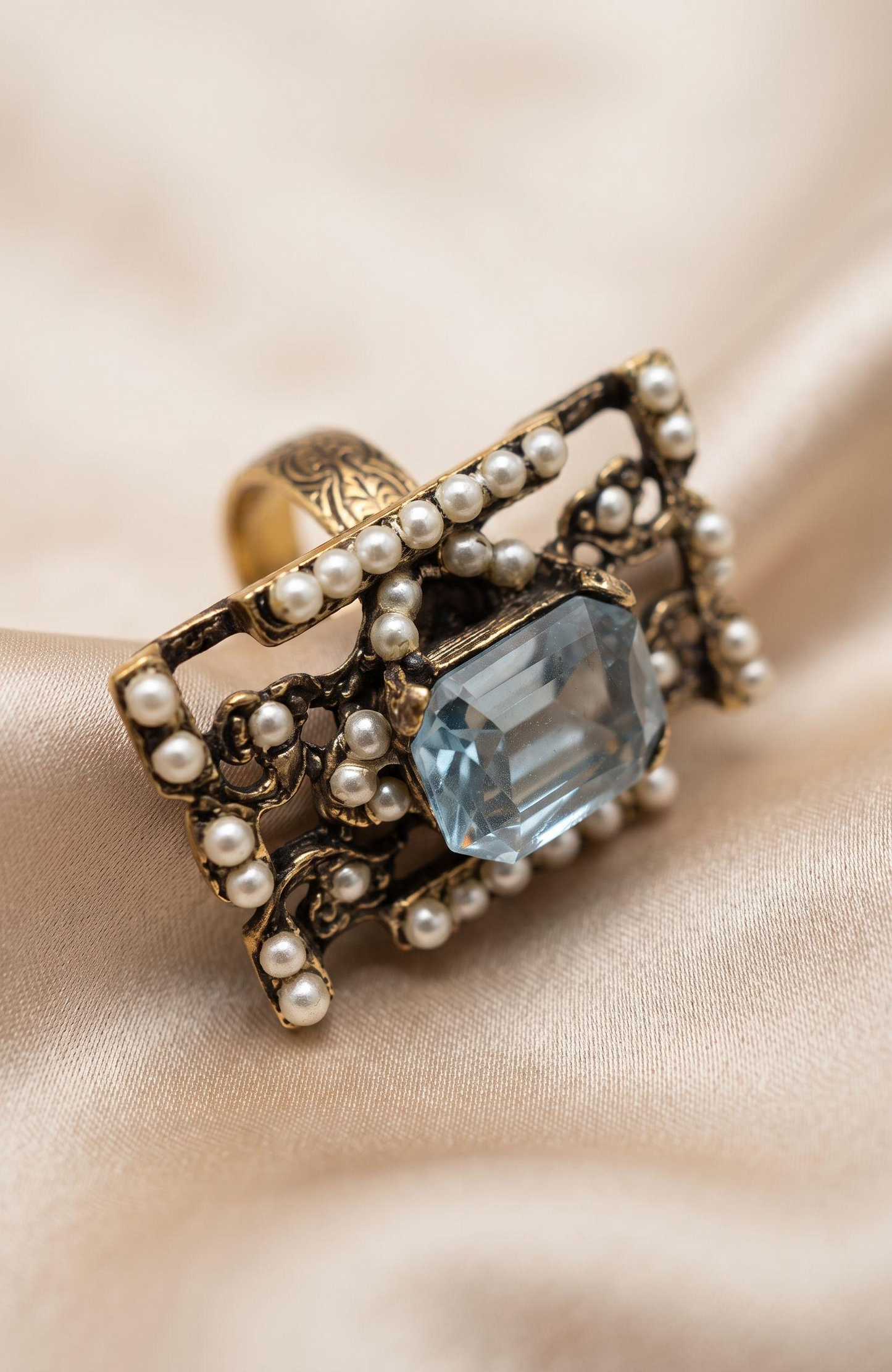 elegant 1940s jumbo cocktail ring with faux aquamarine  center stone  and seed pearls.
