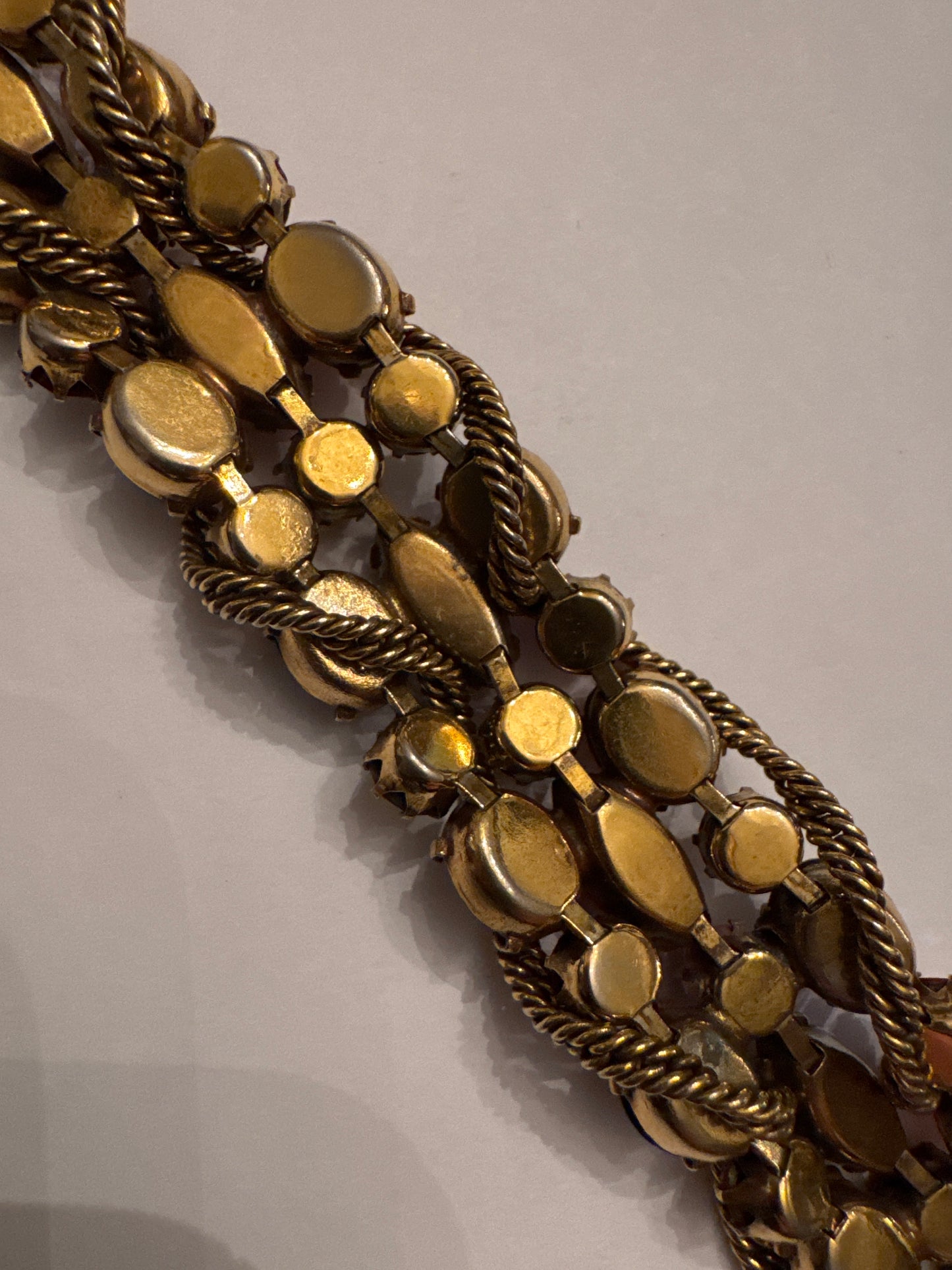 1950s signed KRAMER of NY rhinestone bracelet featuring red crystals and aurora borealis with a gold link chain throughout ￼