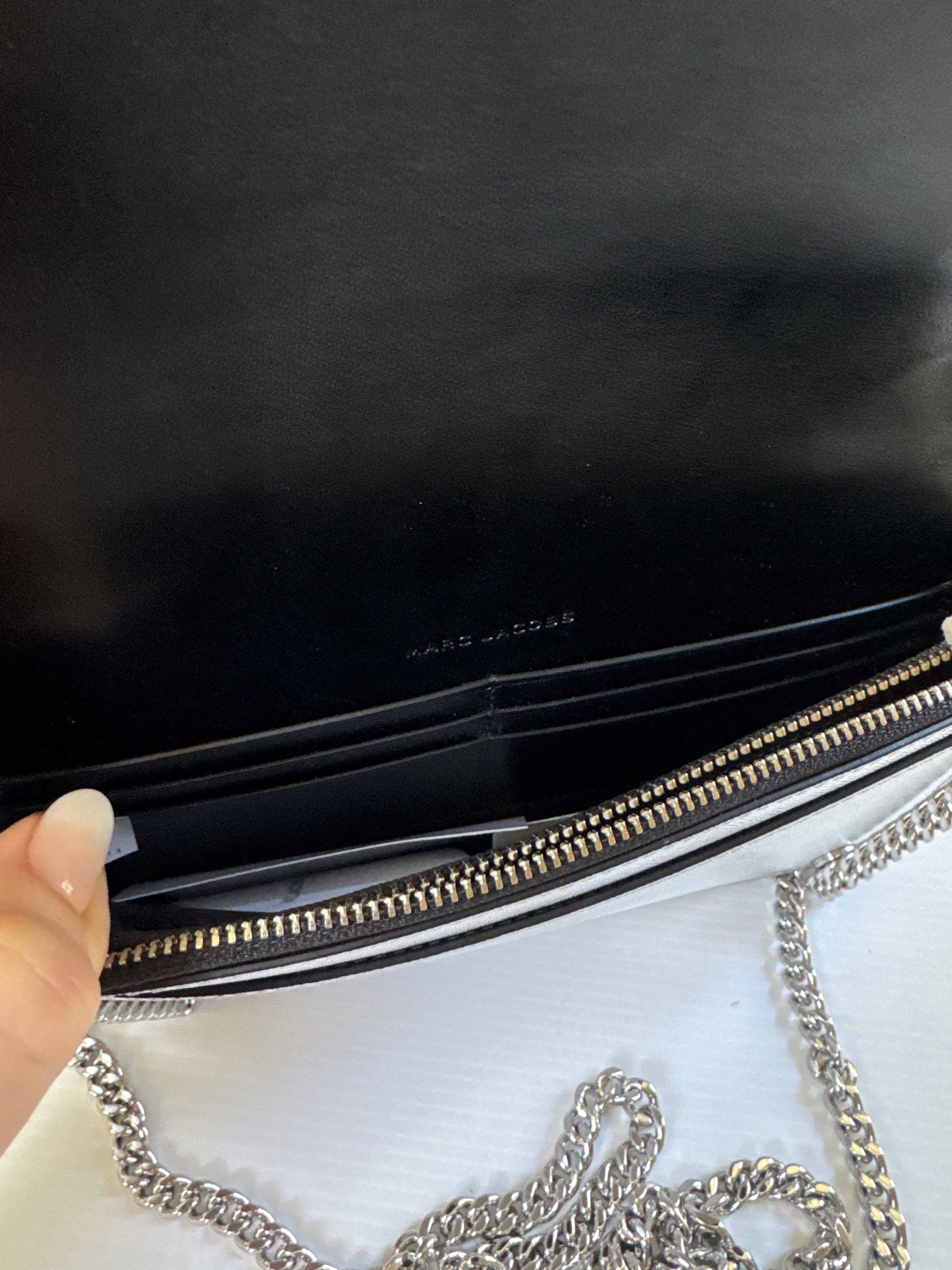 Never worn 1990s Marc Jacob's silver leather clutch with optional strap. Zippered interior and credit card slots plus a small back pocket.