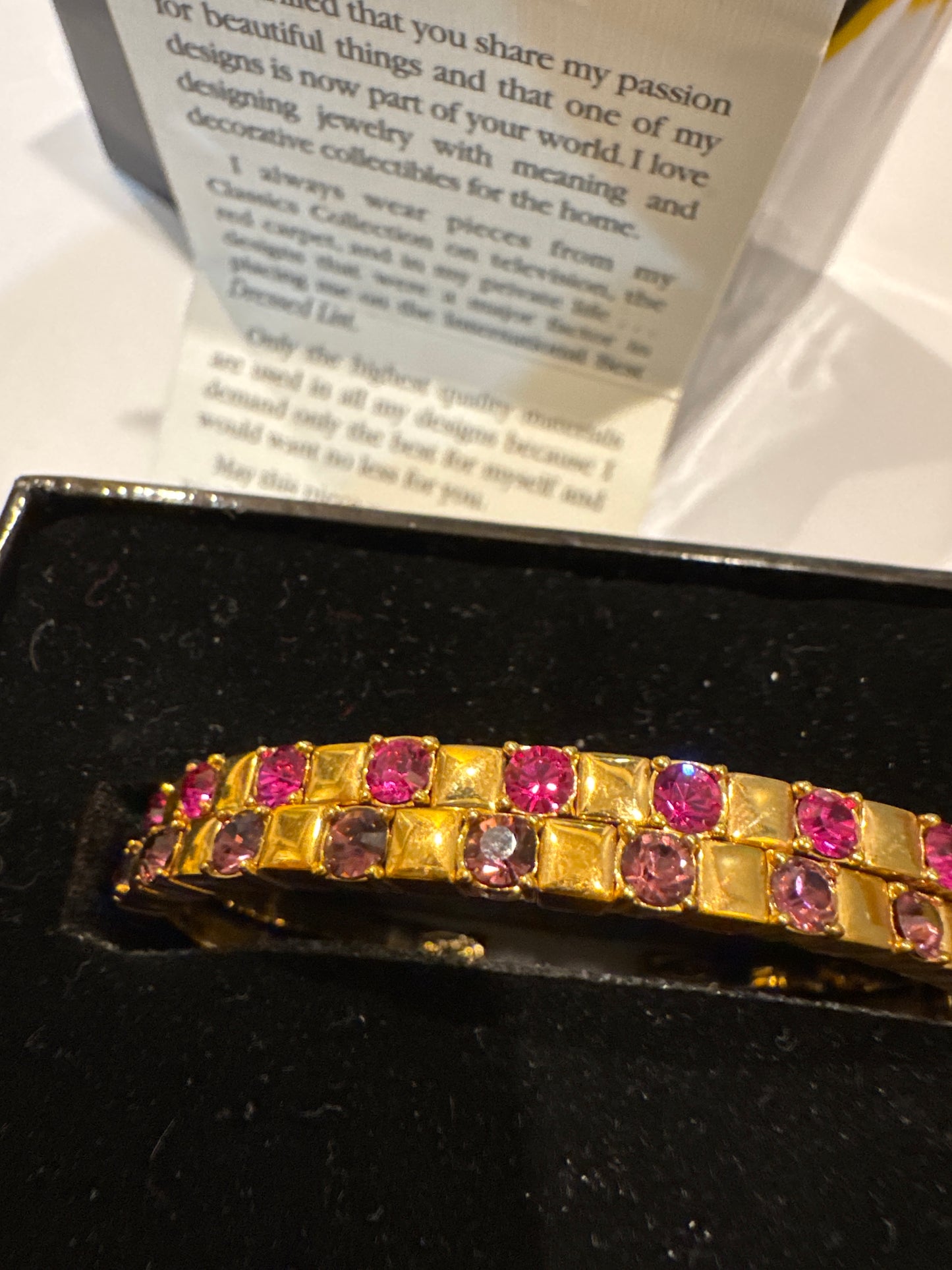 Joan Rivers classic collections rhinestone bangles, one pink one purple.