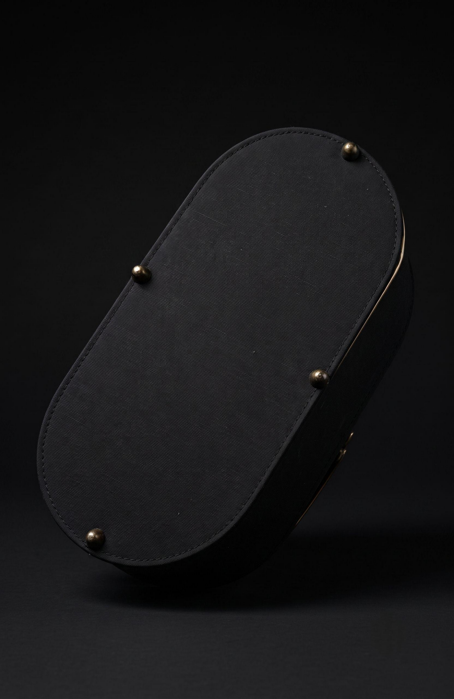 It is a 1940s black suede box Bag with woven suede and gold tone detailing
