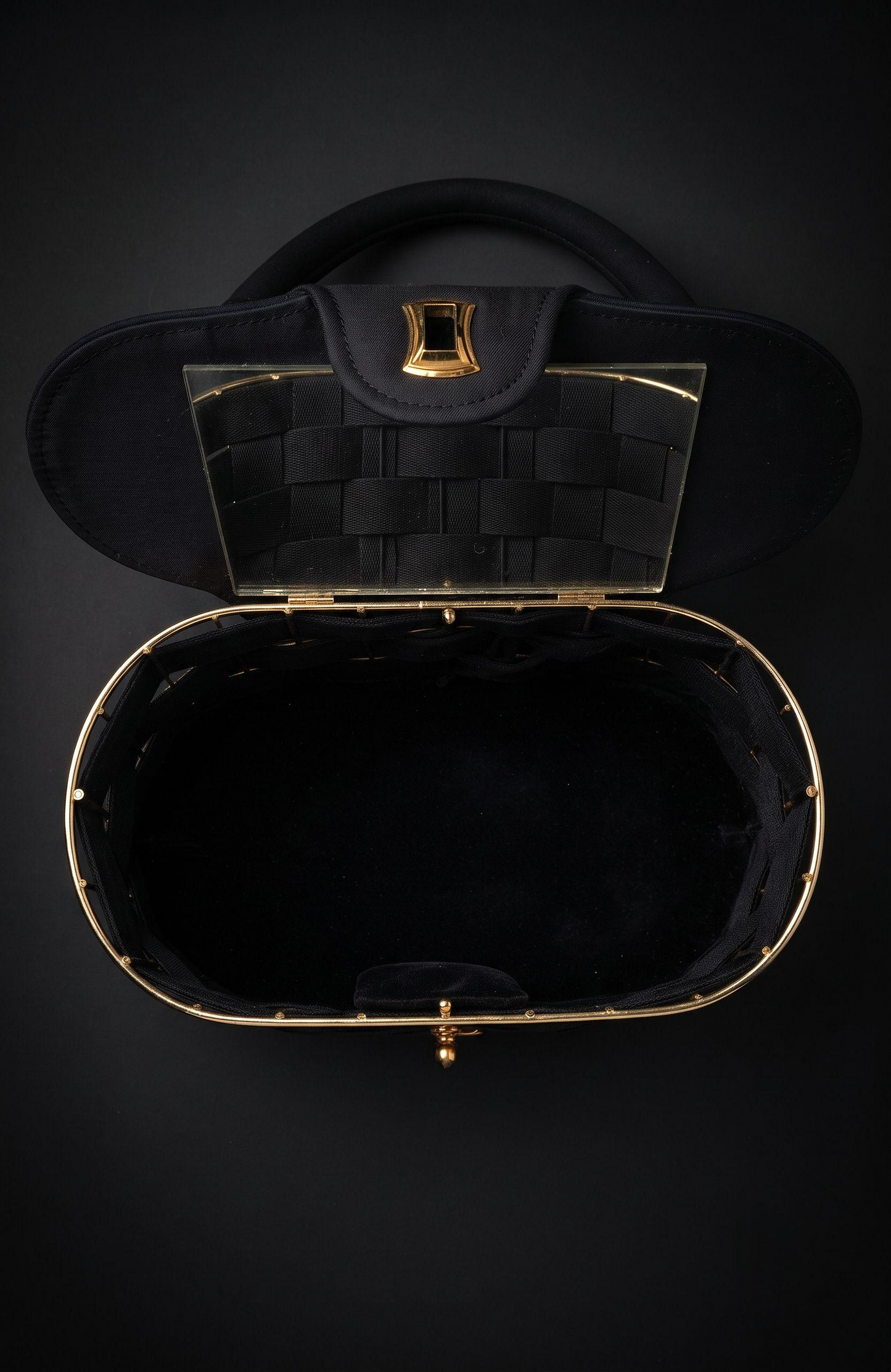 It is a 1940s black suede box Bag with woven suede and gold tone detailing