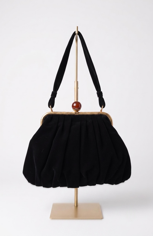 Bag is black suede 1940s with a bakelite top clasp
