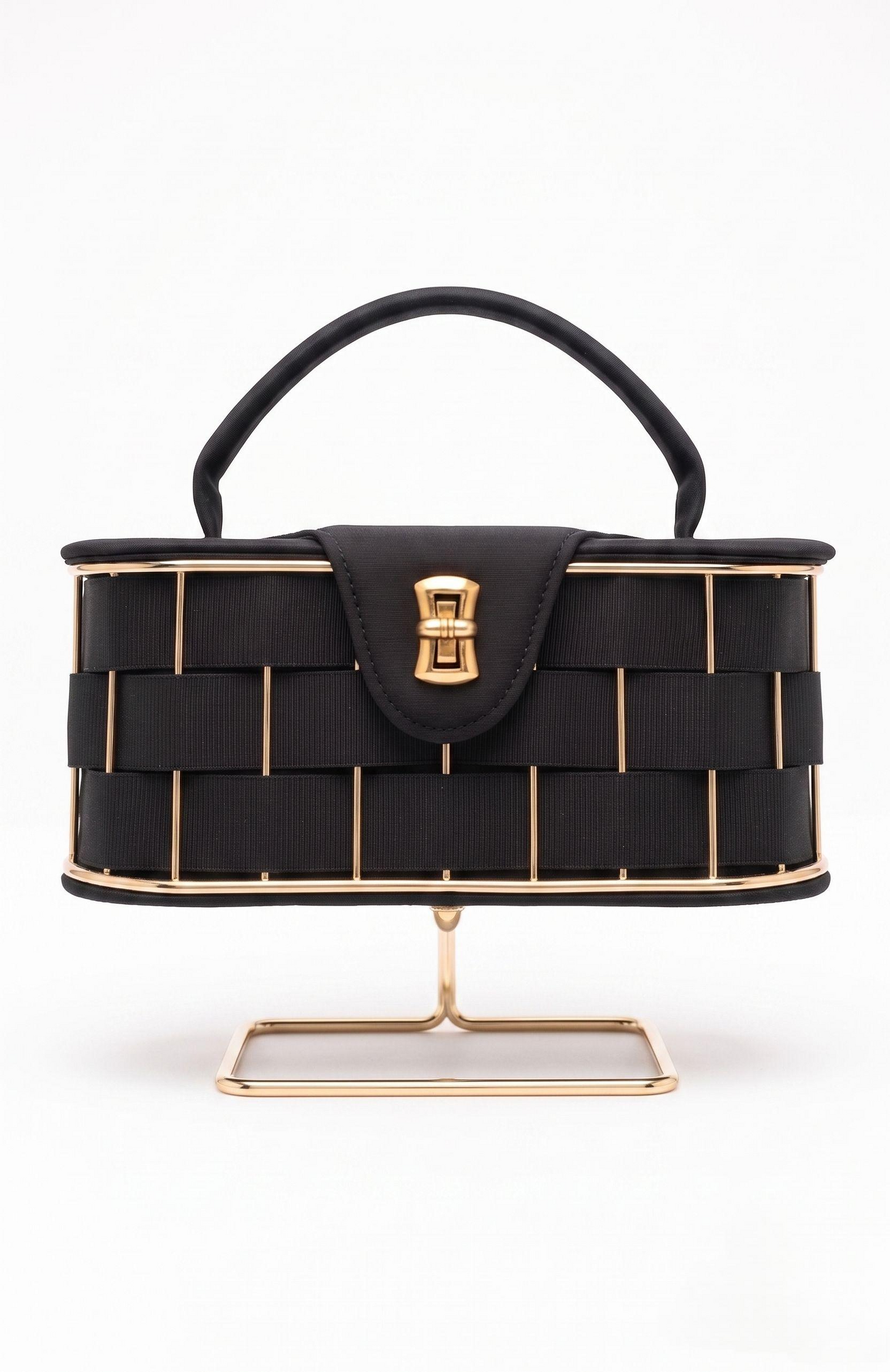 It is a 1940s black suede box Bag with woven suede and gold tone detailing