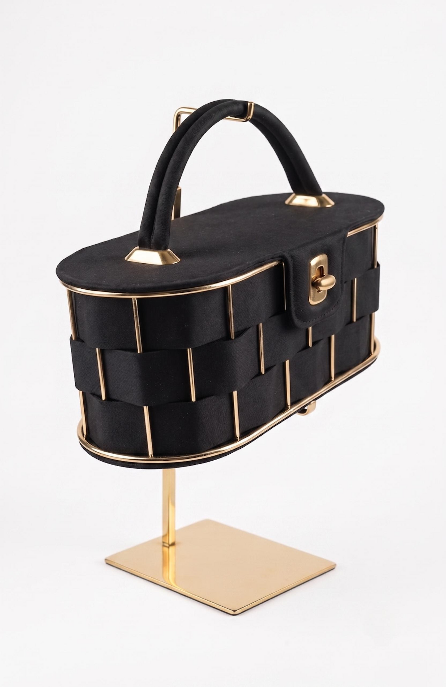 It is a 1940s black suede box Bag with woven suede and gold tone detailing