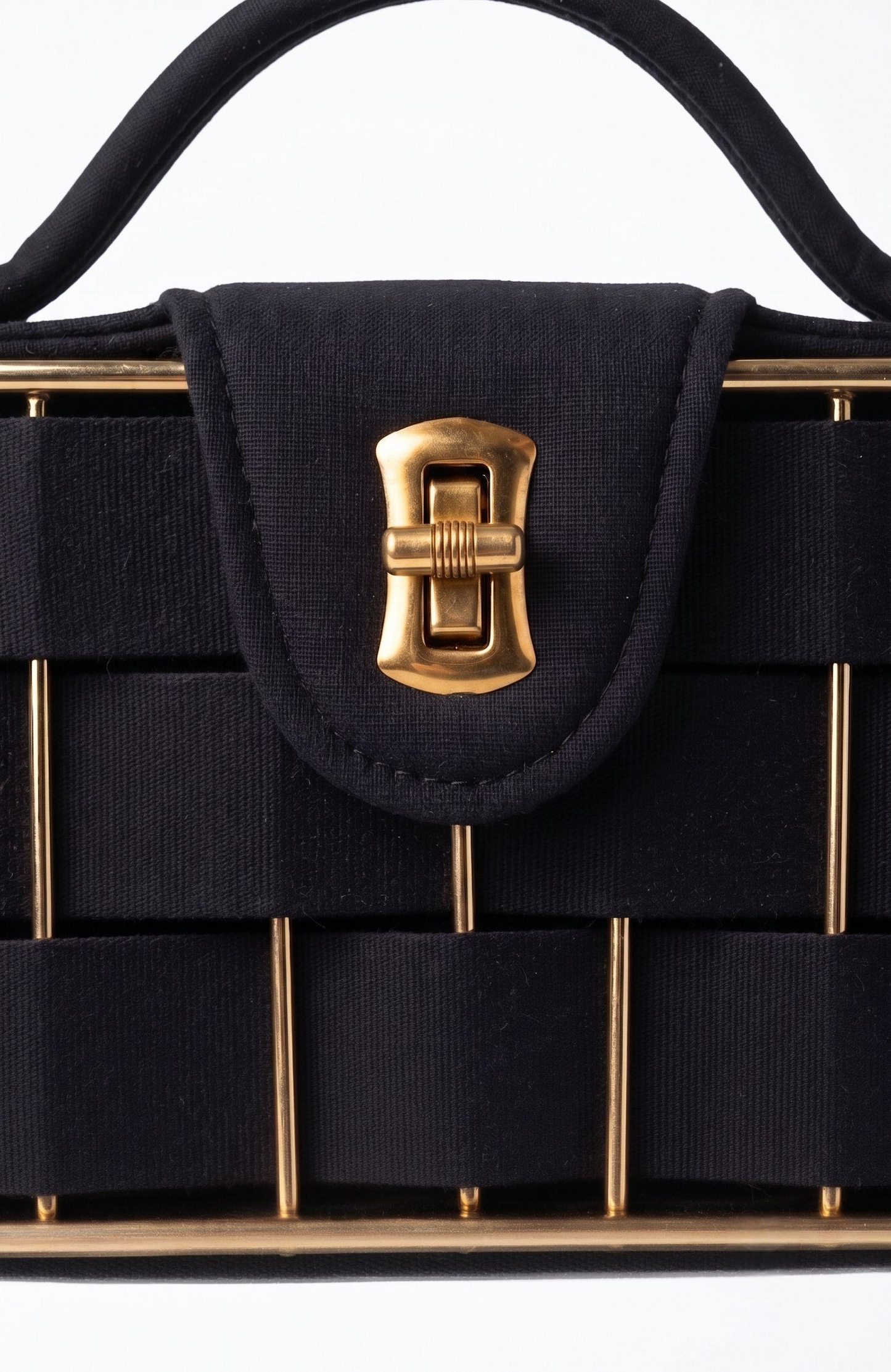It is a 1940s black suede box Bag with woven suede and gold tone detailing