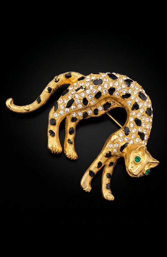 1960s panther brooch with clear, crystal rhinestones and emerald colored eyes. Black enamel spots ~ some need a little touchup, or not.