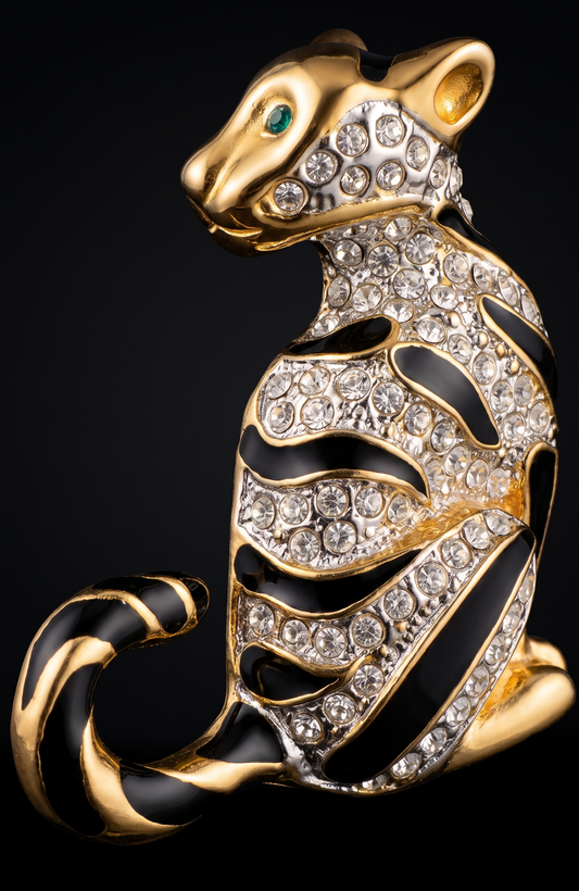 1980s jumbo gold tone, black enamel, and clear rhinestone cheetah brooch with green emerald eyes