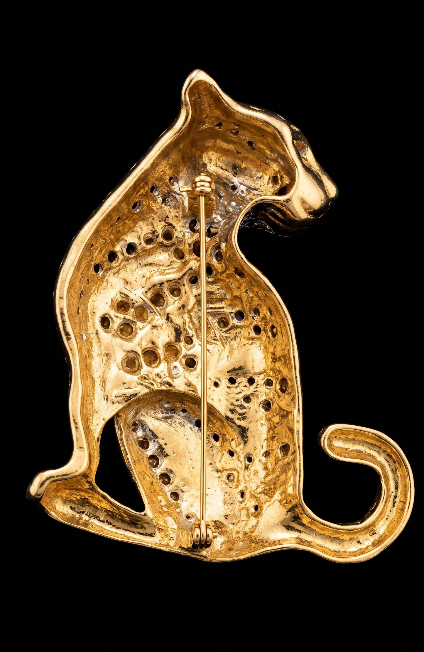 1980s jumbo gold tone, black enamel, and clear rhinestone cheetah brooch with green emerald eyes