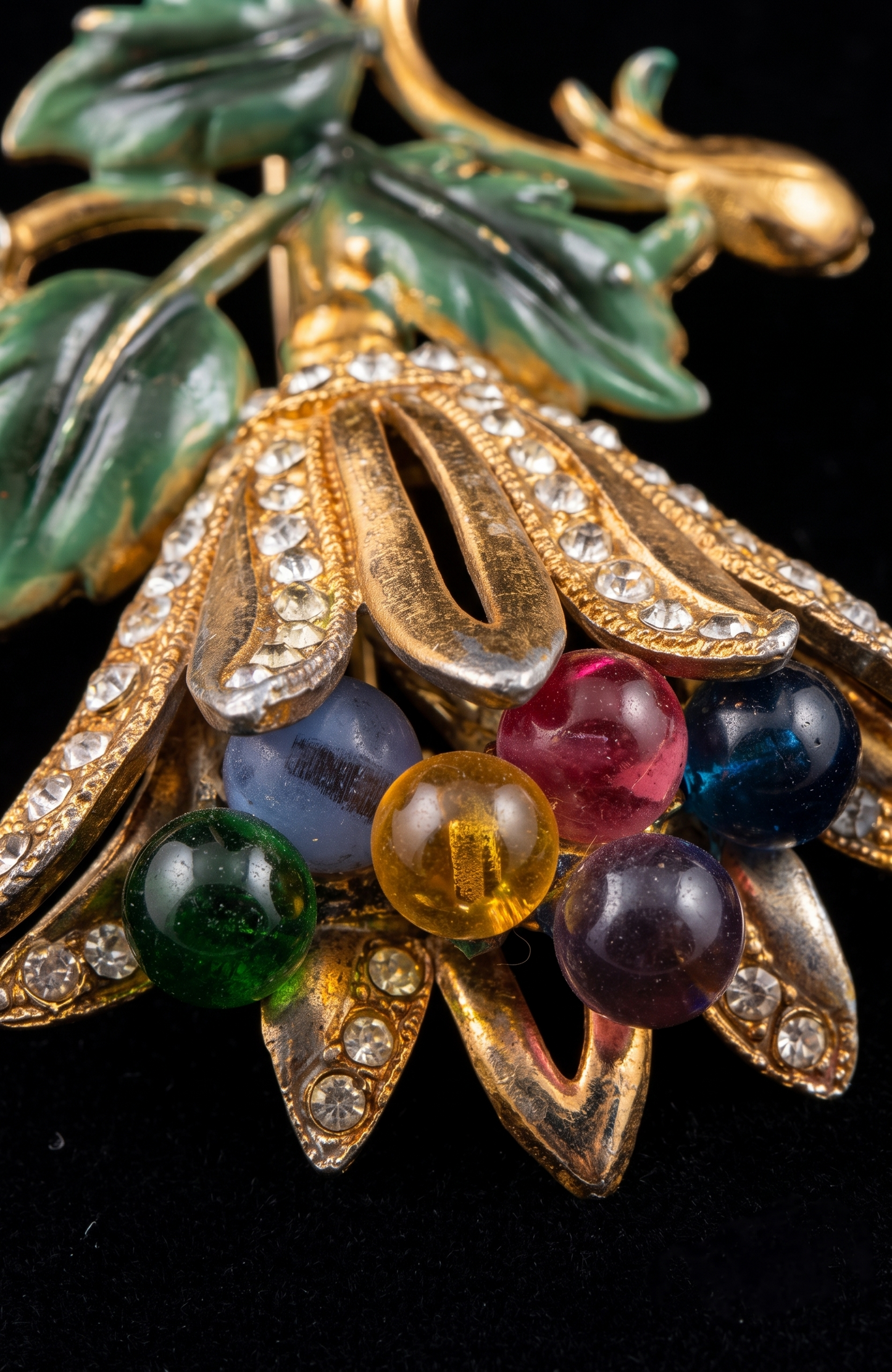Signed HAGLER  tutti frutti floral spray brooch, late 1940–early 1950s, featuring molded lucite leaves, multicolored glass bead berries, and rhinestone-set gold-tone petals. Hand-assembled with open architectural construction.