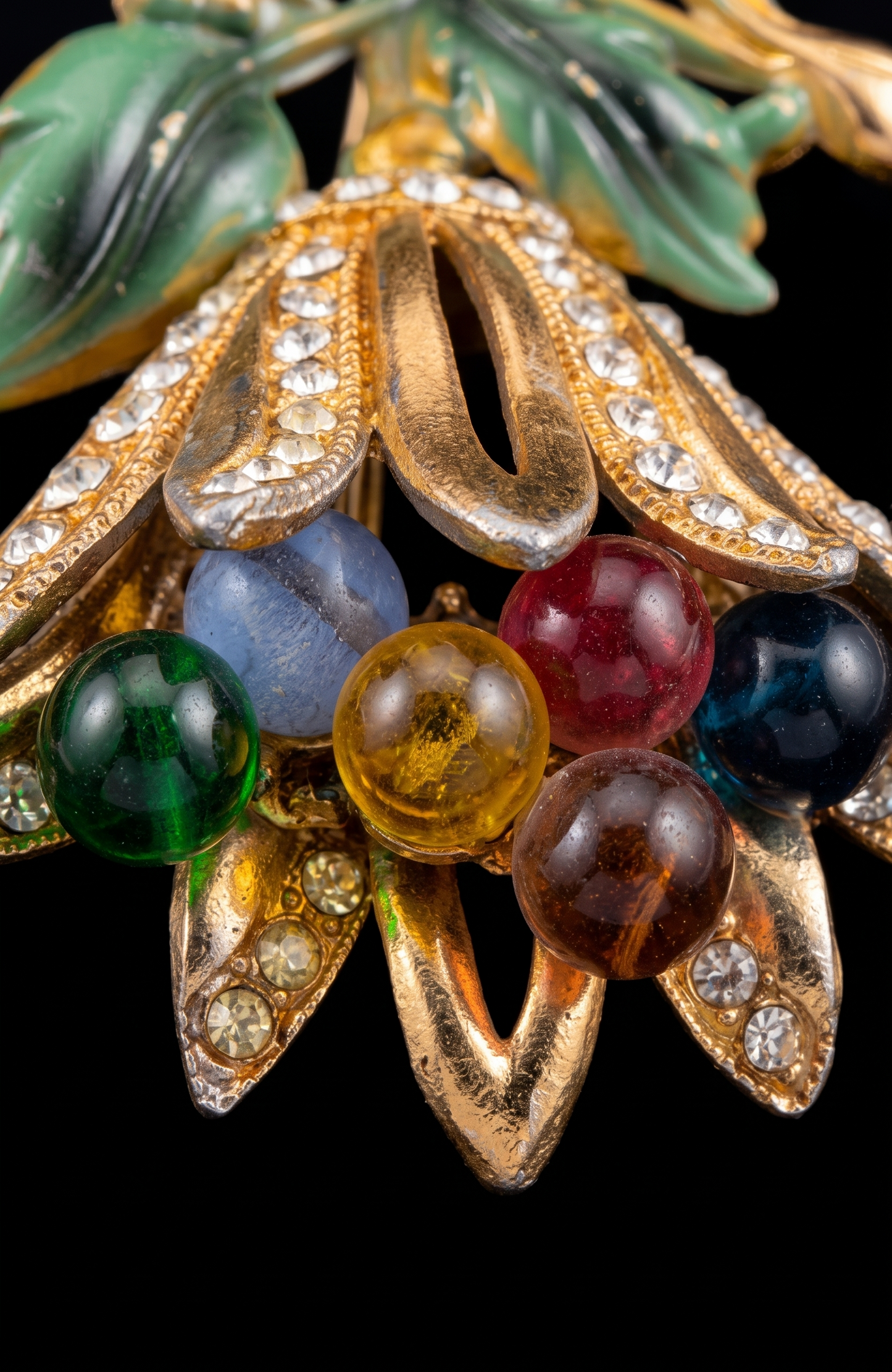 Signed HAGLER  tutti frutti floral spray brooch, late 1940–early 1950s, featuring molded lucite leaves, multicolored glass bead berries, and rhinestone-set gold-tone petals. Hand-assembled with open architectural construction.