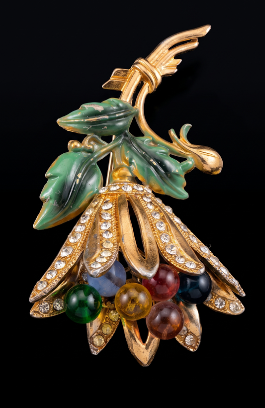 Signed HAGLER  tutti frutti floral spray brooch, late 1940–early 1950s, featuring molded lucite leaves, multicolored glass bead berries, and rhinestone-set gold-tone petals. Hand-assembled with open architectural construction.