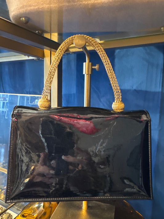 Beautiful 1950s patent leather top handle bag with gold filigree handle. Absolutely stunning