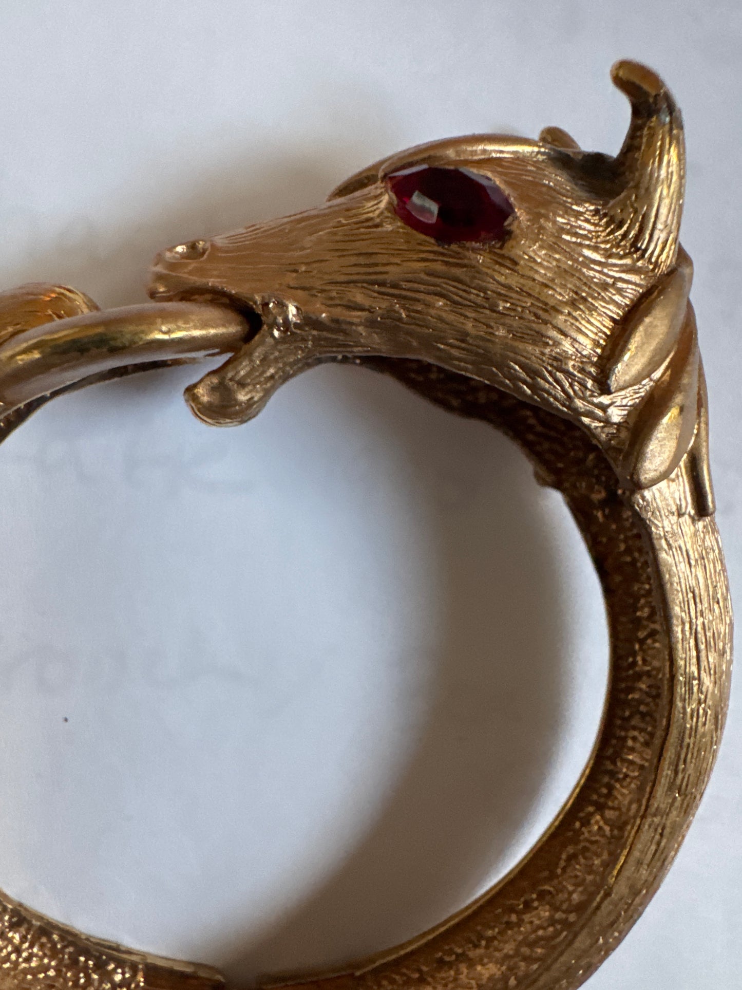 1960s signed PAULINE RADER gold tone ram clamper with ruby rhinestone eyes.