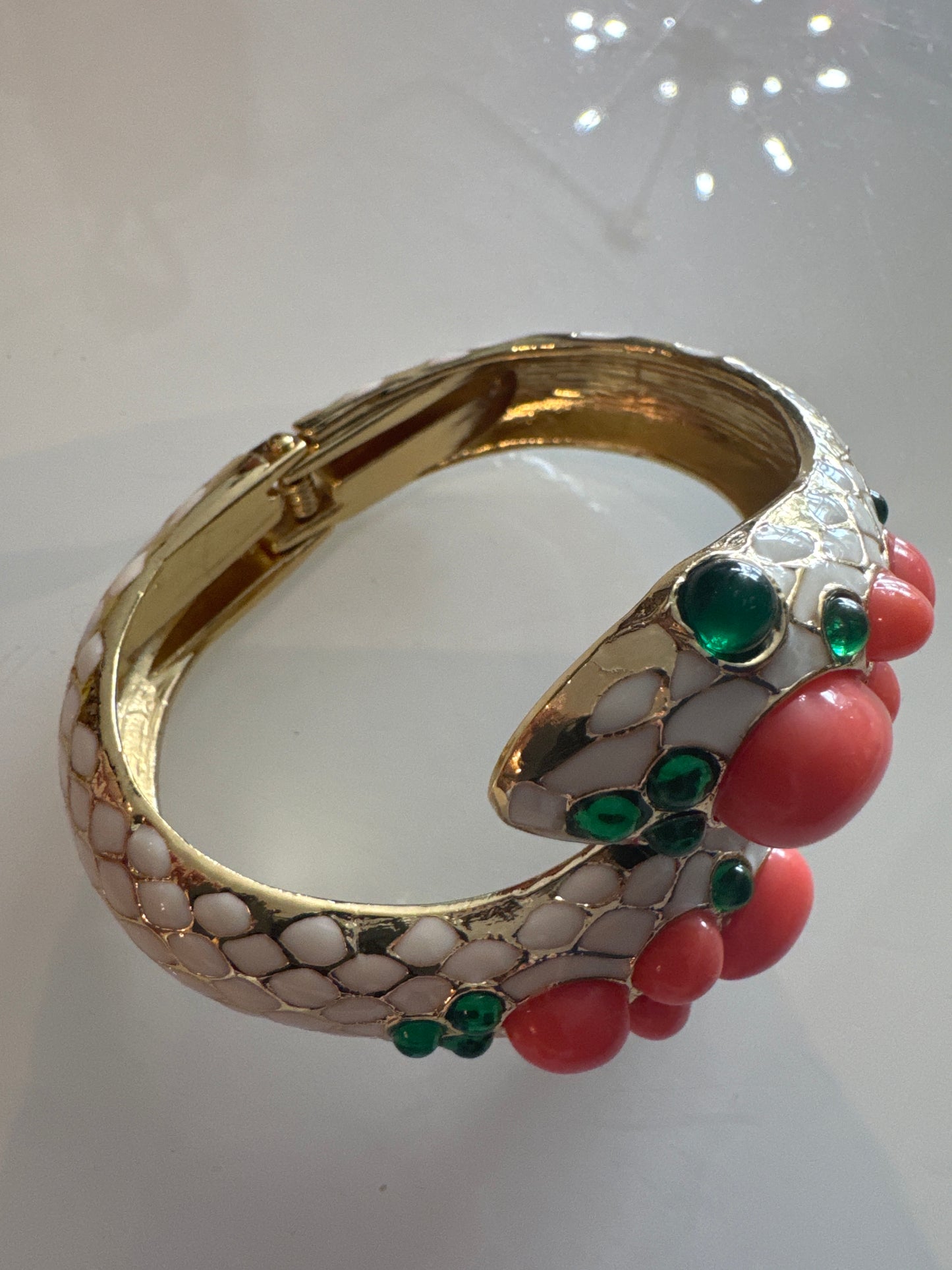 Trifari gorgeous 1968 snake clamper bracelet with green glass and faux coral cabachon stones. Unsigned from L'Orient Collection