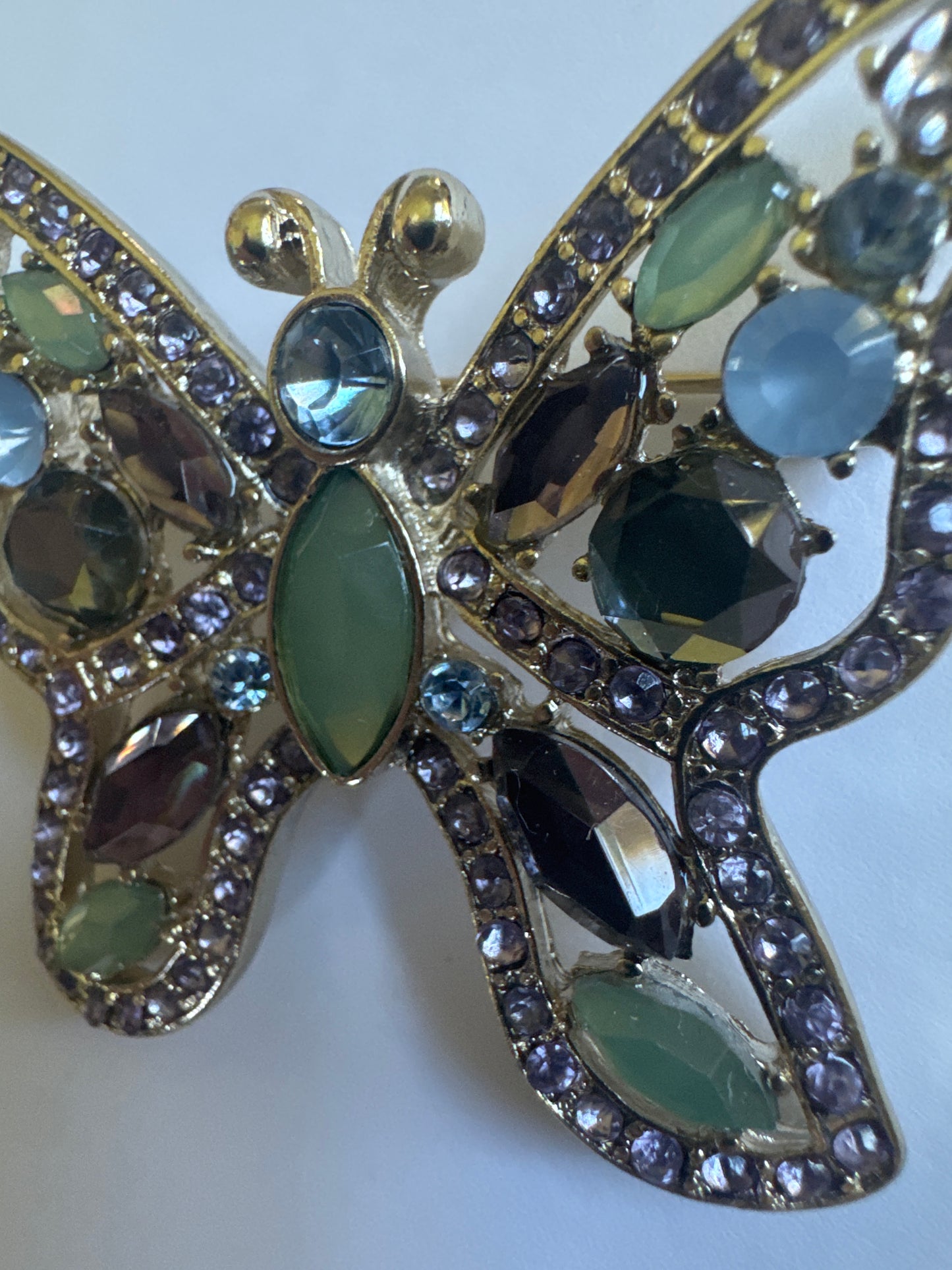 1990s silver tone signed NAPIER butterfly brooch with light green and blue rhinestones