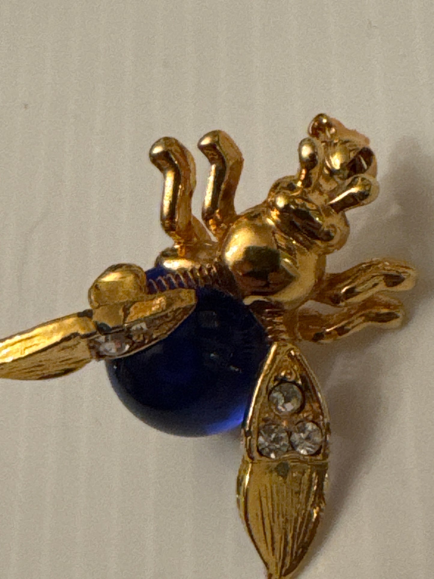 Unsigned vintage jelly belly trembler brooch attributed to Trifari (Alfred Philippe era), circa late 1940s, featuring a cobalt-blue glass cabochon body and spring-mounted tremble head. A RARE collectible.
