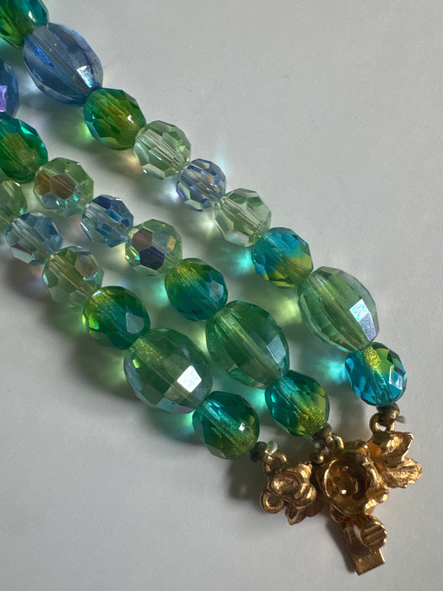 Unsigned attributed to Schiaparelli crystal bracelet with green and blue beads. Clasp points us in the direction of Schiaparelli along with the gradation of colors used.