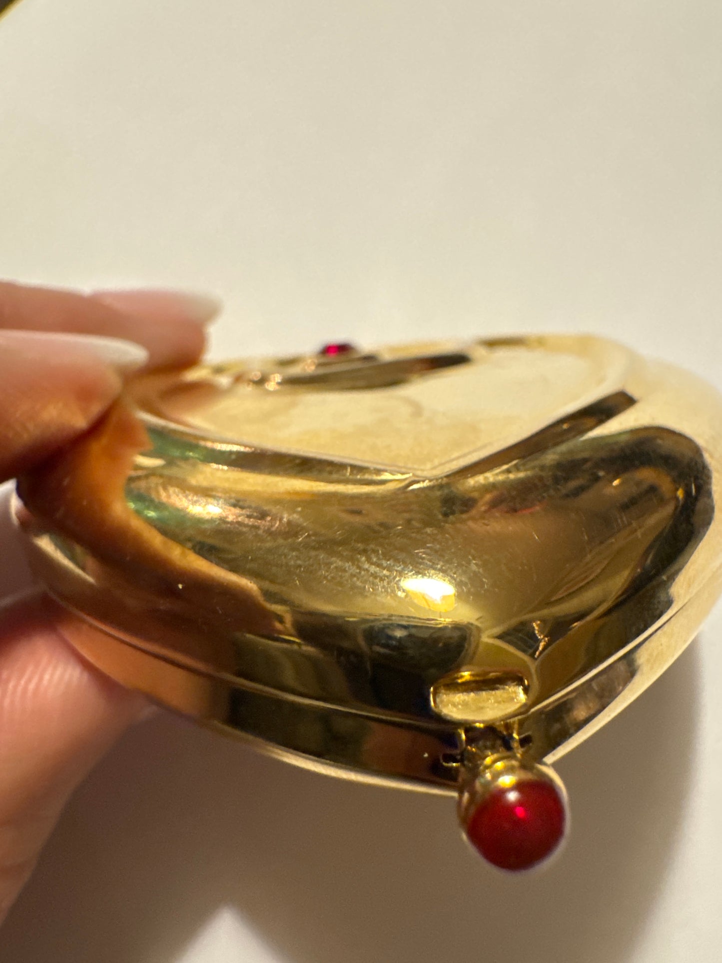 Vintage Estée Lauder powder gold tone heart compact with red stones. Road