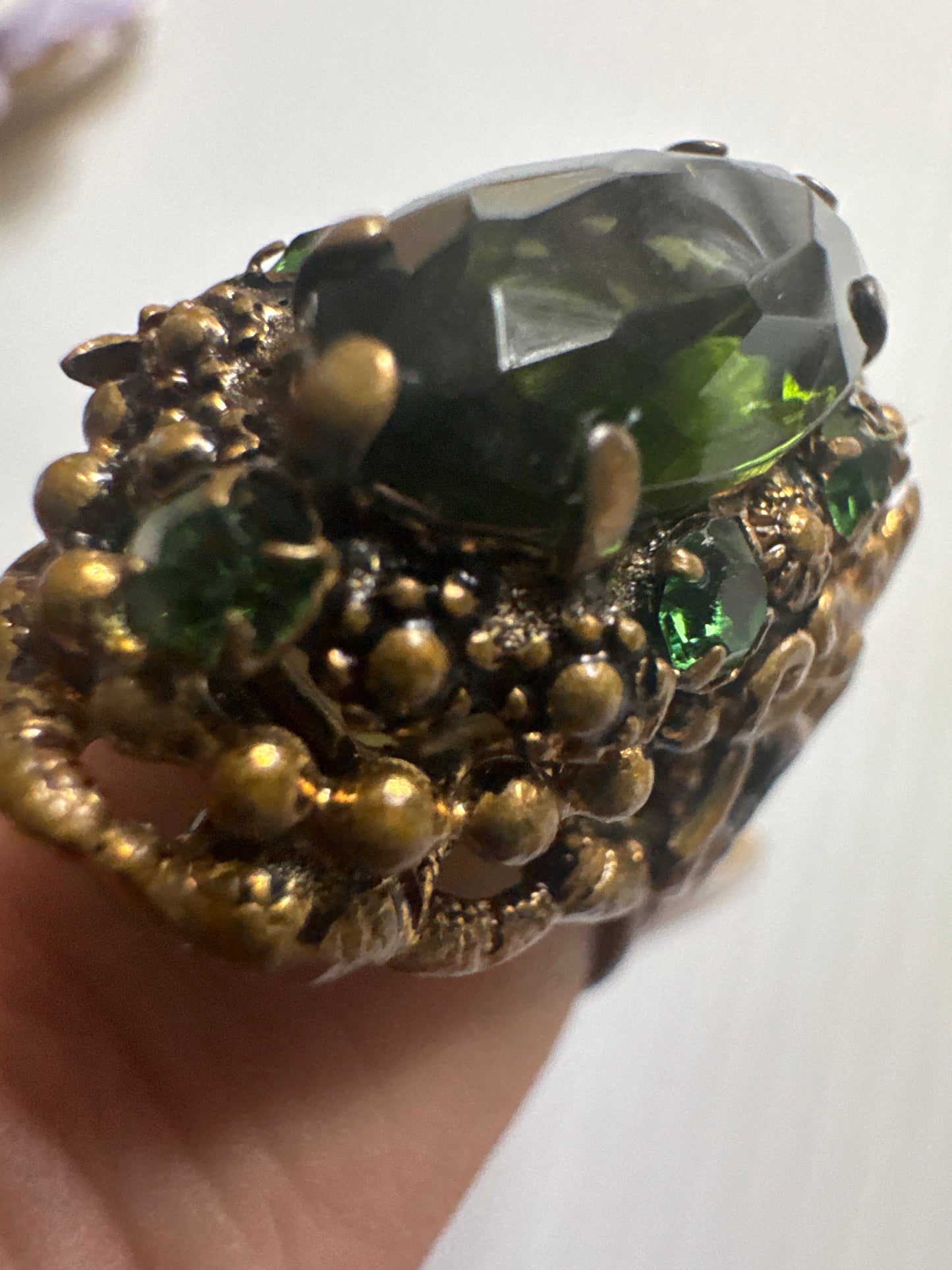 fabulous 1940s Czech glass ring with filigree detail, large green center stone and small green stones in setting