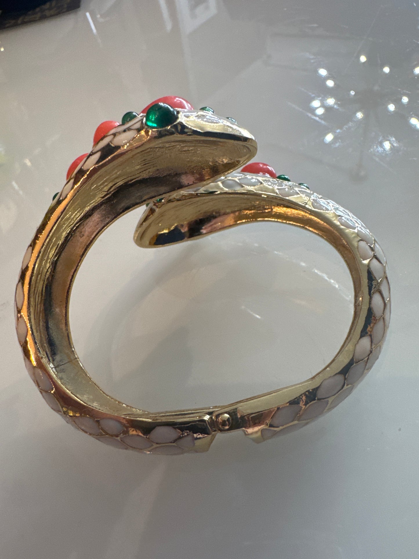 Trifari gorgeous 1968 snake clamper bracelet with green glass and faux coral cabachon stones. Unsigned from L'Orient Collection