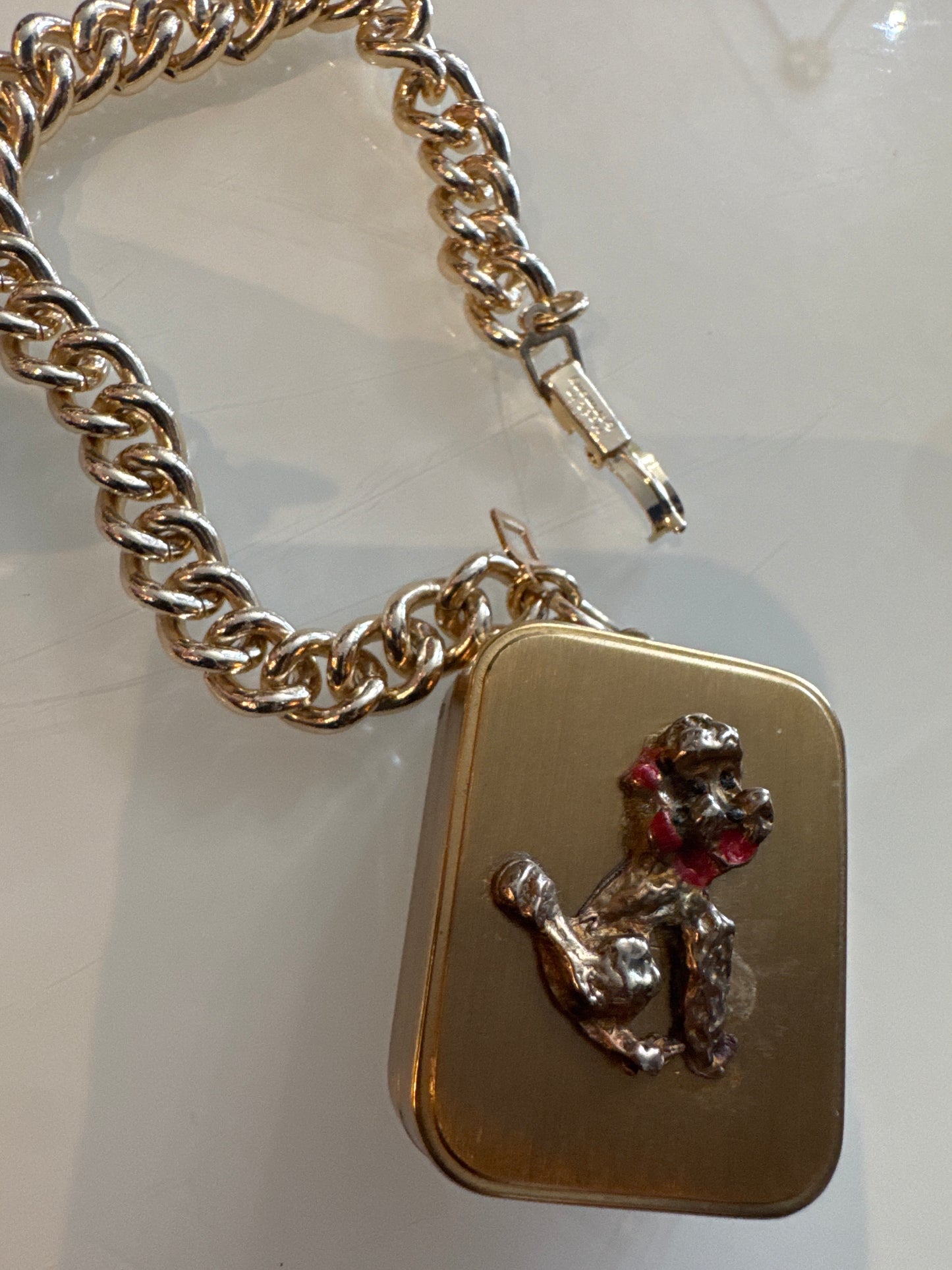 1960s poodle music box charm bracelet. Music back wines, but no longer plays .signed made in Germany.