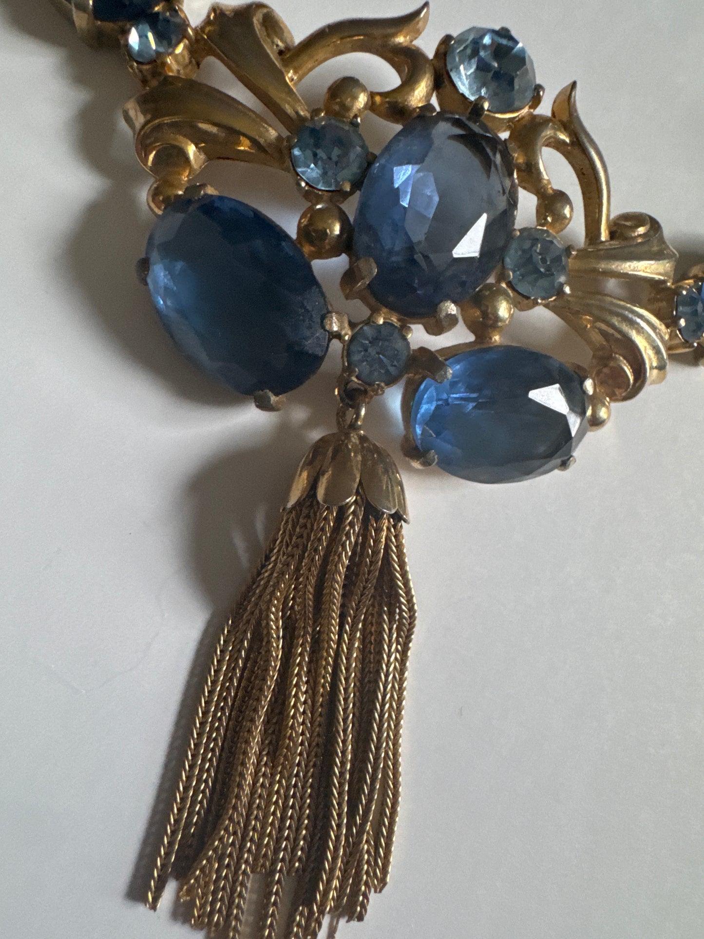 Absolutely gorgeous 1930s signed Schiaparelli necklace featuring shades of blue glass beads with tassel dangle, and J clasp closure
