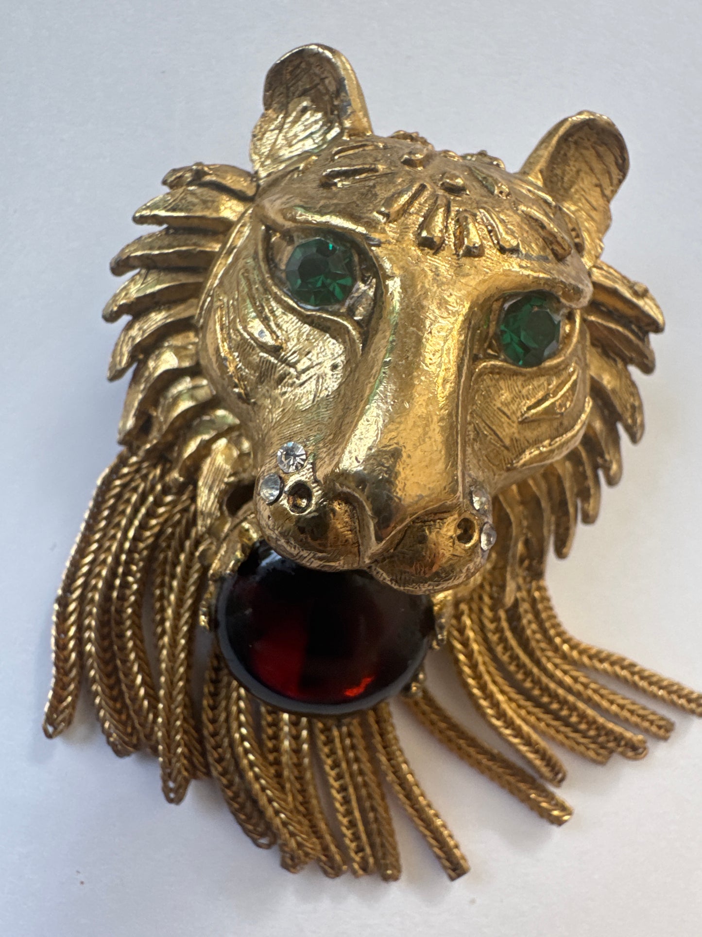 Coveted and hard to find 1960s unsigned lionhead tassel brooch attributed to Pauline Rader ~ this one being an amber glass cabochon with green rhinestone eyes. The wonderful coil fringe lions mane is fabulous.