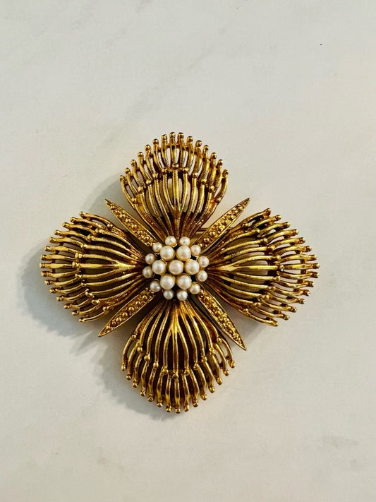 Vintage Monet gold tone flower shaped brooch with pearl center