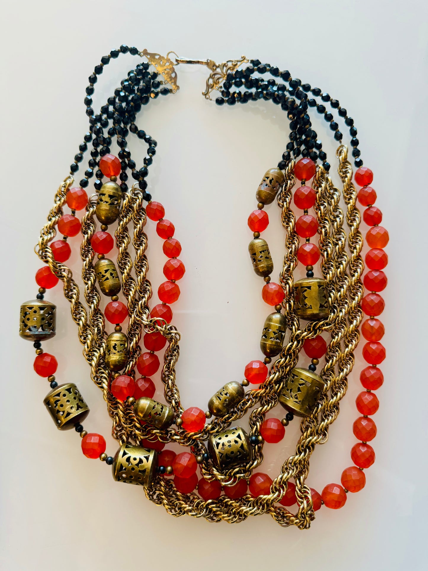 Vintage multi strand gold tone necklace with black jet beads and orange and gold beads