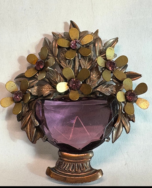 1940 gold guilded flowers with large amethyst matching glass stone. Unsigned book piece from All my Baskets by G.
Mariotti. Extremely rare and highly sought after.