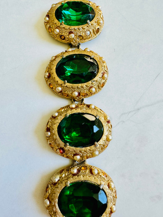 Vintage gold tone bracelet with jumbo green stones and tiny amber and pearl surrounding the stone