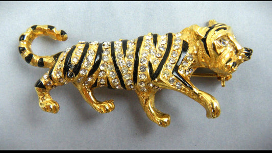 1960s Hattie Carnegie panther brooch features enameled stripes and crystal clear chatons.