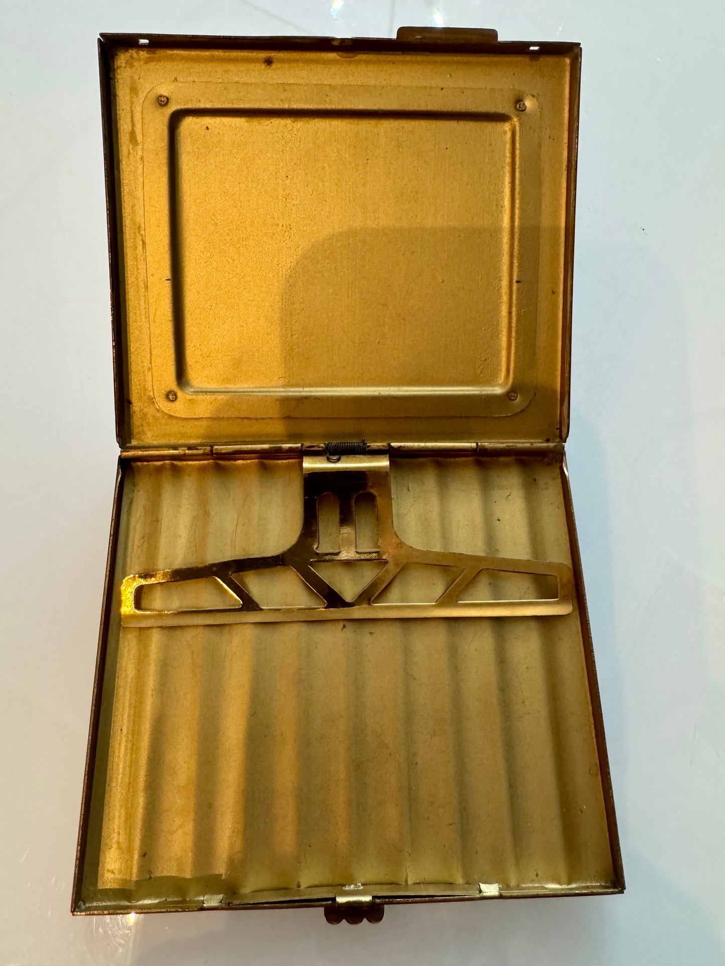 Vintage 1940s cigarette case with coupling scene made from foil.