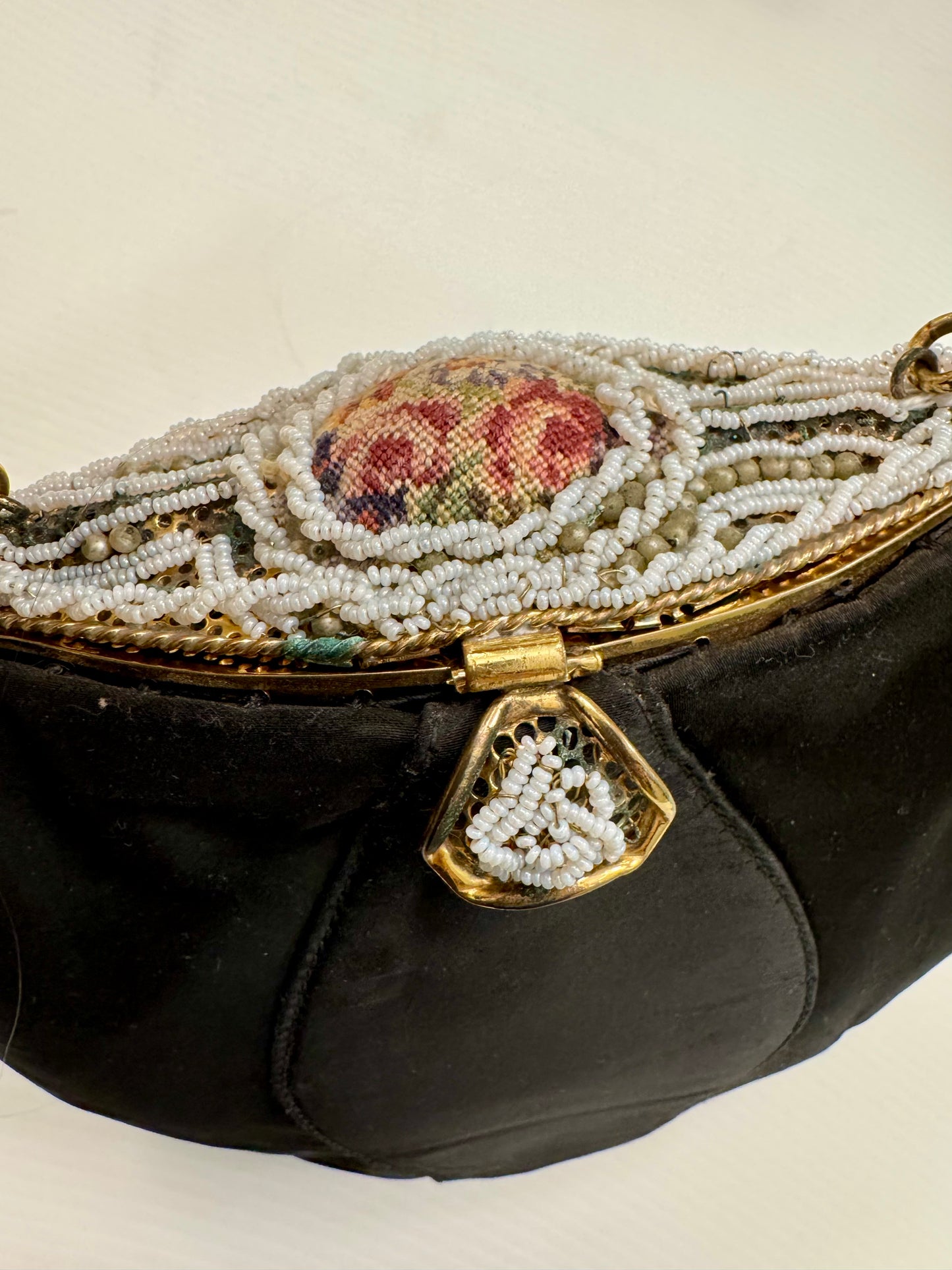 1940s black satin top handle handbag with decorative bead clasp and top design. Absolutely stunning!