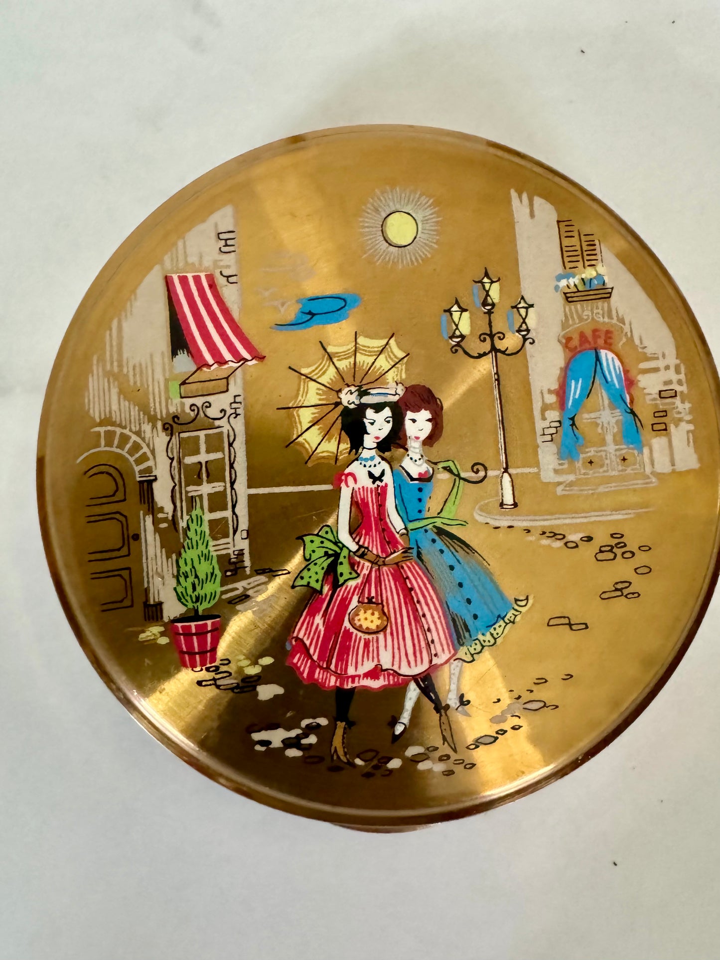 Vintage makeup compact with girlfriends walking