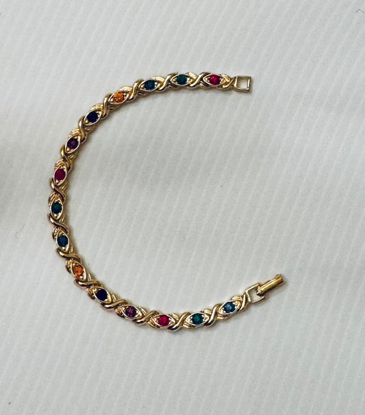 Vintage 1980s gold tone bracelet with rainbow colored stones