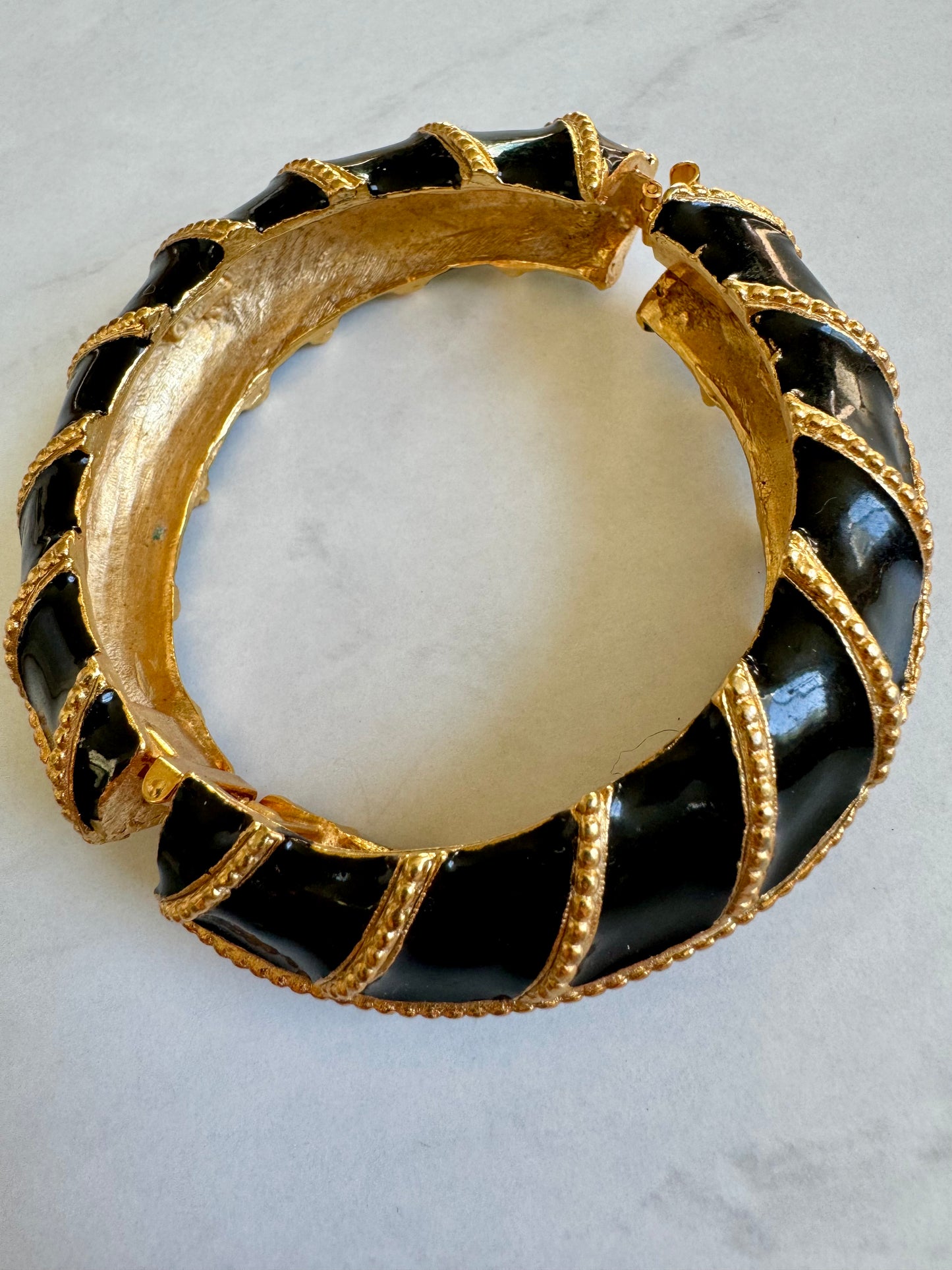 Signed Yosca black and gold tone enamel bangle