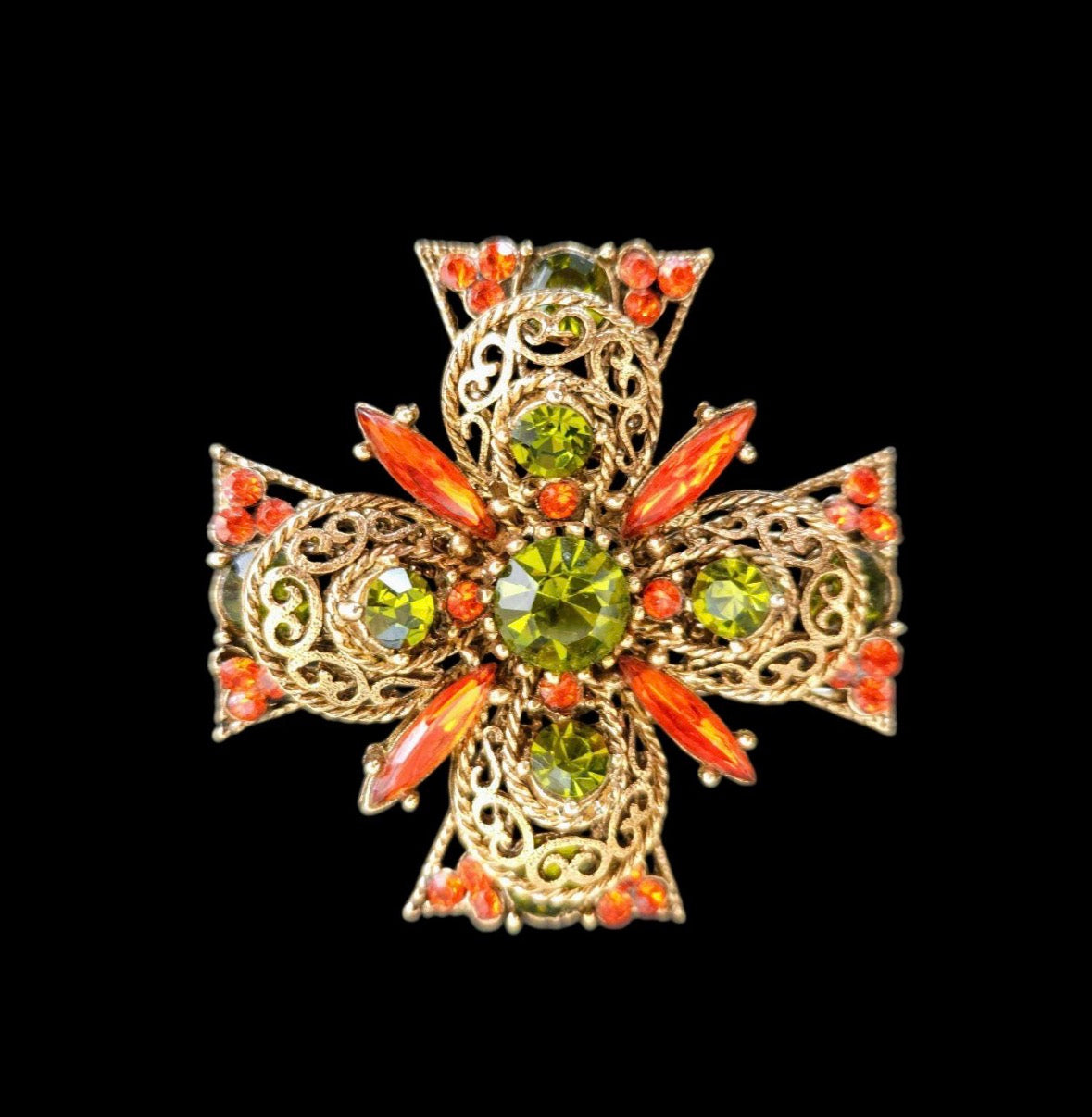 1960s Maltese cross by EMMONS features bright orange and olivine green rhinestones, heart scrolls and gold tone rope trim in a tiered design.