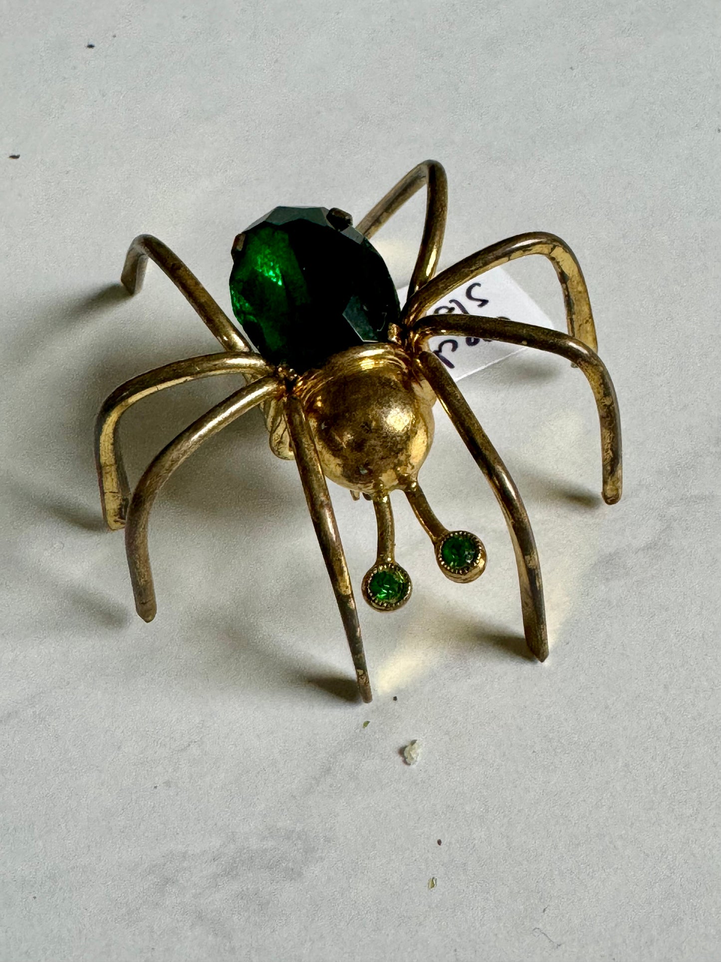 Little Miss Spider brooch made in Czechoslovakia with green rhinestone body and eye and long raised legs