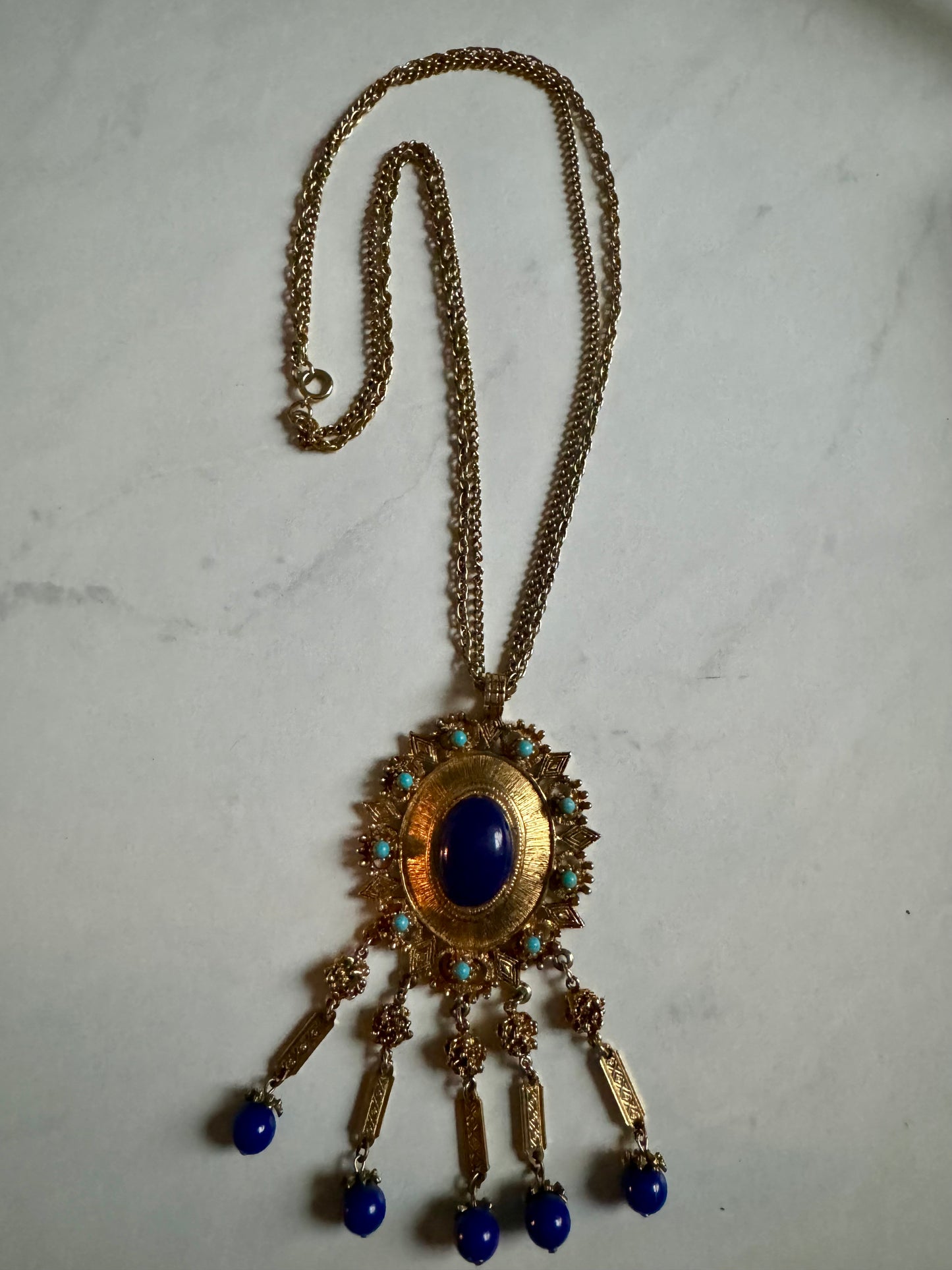 Stunning vintage gold tone necklace with turquoise and blue pendant.