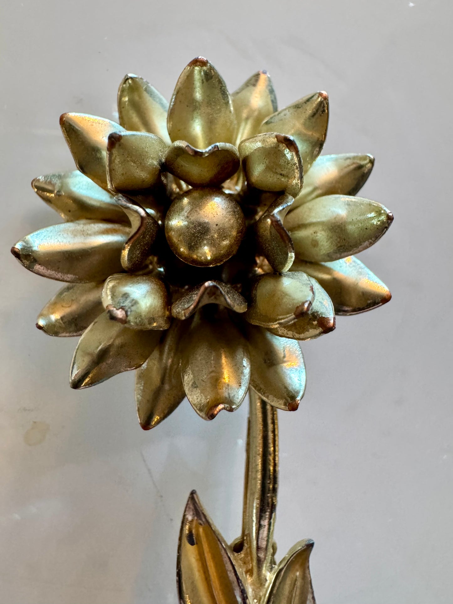 Gold tone vintage flower brooch with leaves and stem