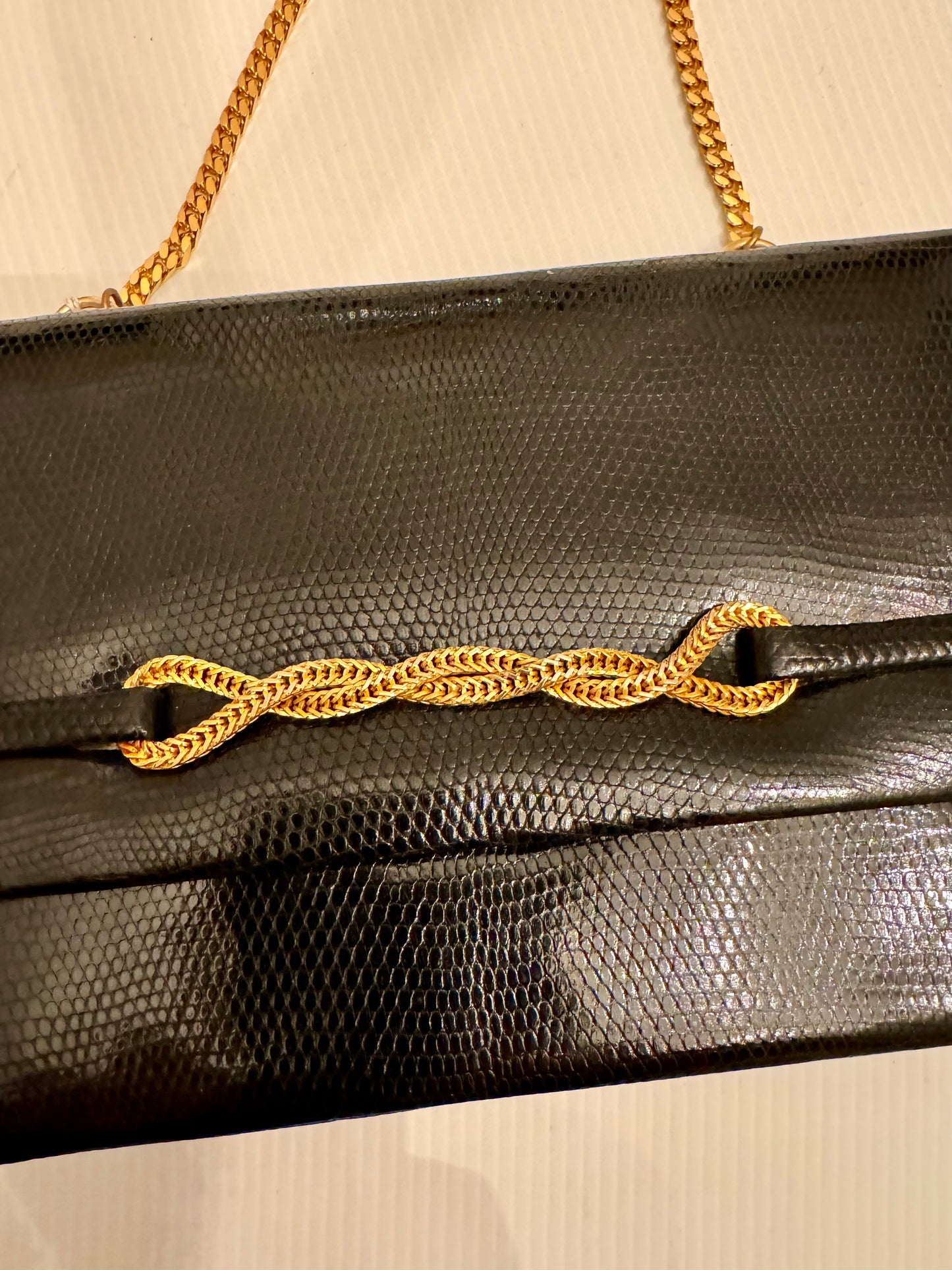 Elegant 1950s lizard black handbag with gold chain closure and gold tone chain shoulder strap