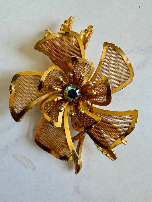 Classic gold tone mesh flower brooch with center rhinestone