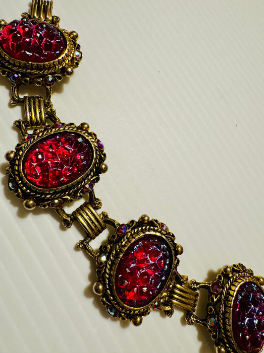 1950s gold tone and red center stone surrounded with tiny watermelon stones