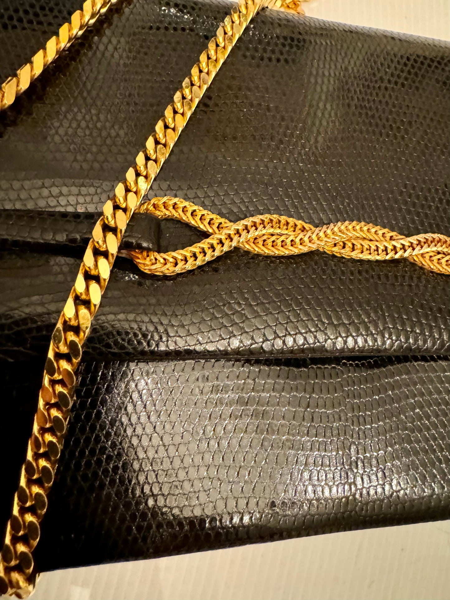 Elegant 1950s lizard black handbag with gold chain closure and gold tone chain shoulder strap