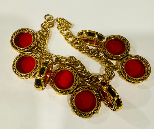 Vintage 1950s gold tone red disk with black  charm bracelet